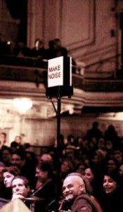 The 'Make Noise' applause light in front of the audience at the 2013 taping of Ask Me Another in the Wilbur Theatre, Boston.