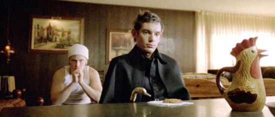 A cinemascope-cropped still from Brick, featuring Lukas Haas and a pitcher incongruously shaped like a chicken. 